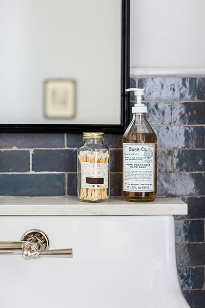 House of Jade Interiors - Winter inspired powder room - Bathroom sink ledge with partial faucet